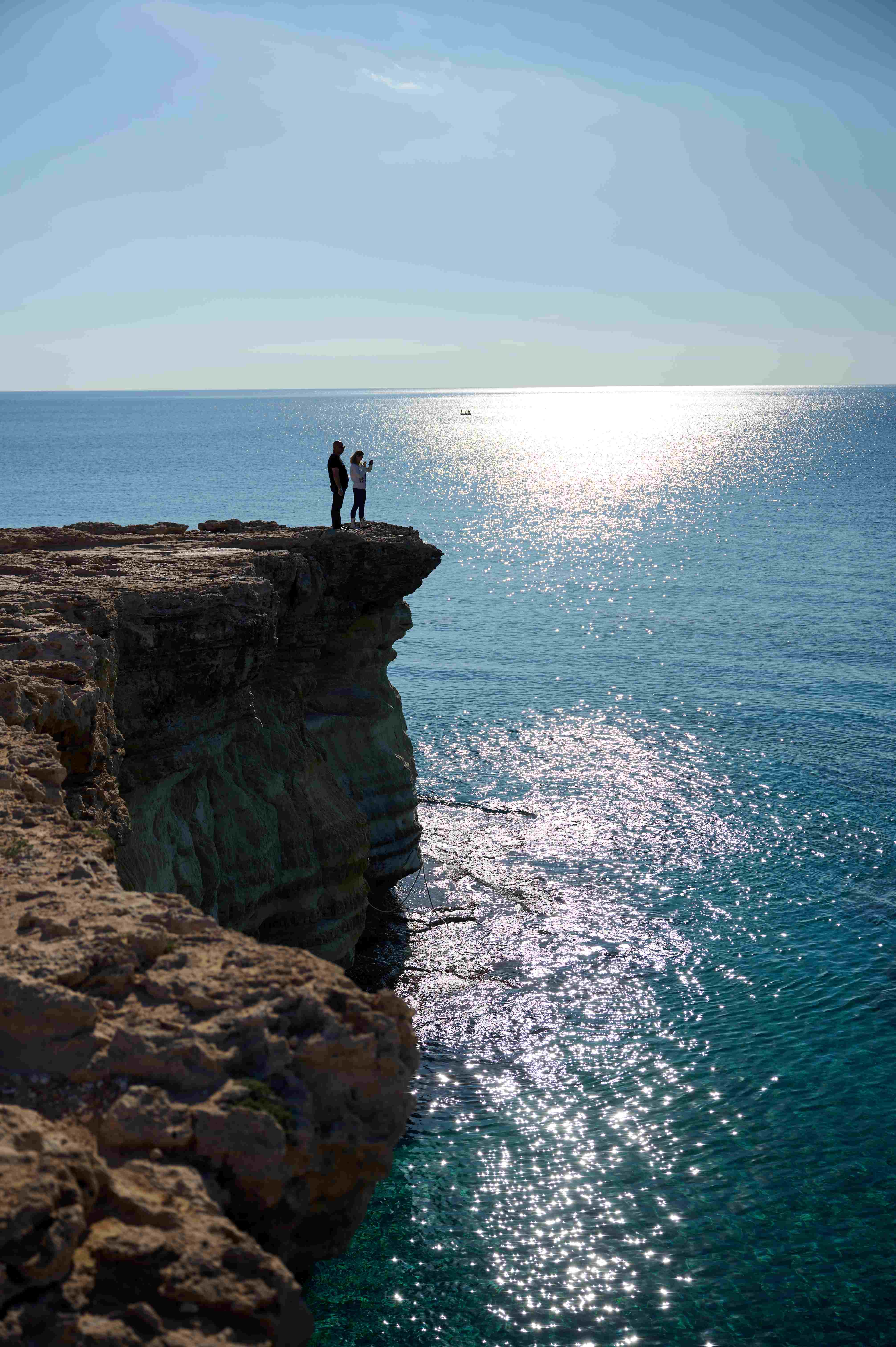 Couple admiring the view from a Cape Greco cliff