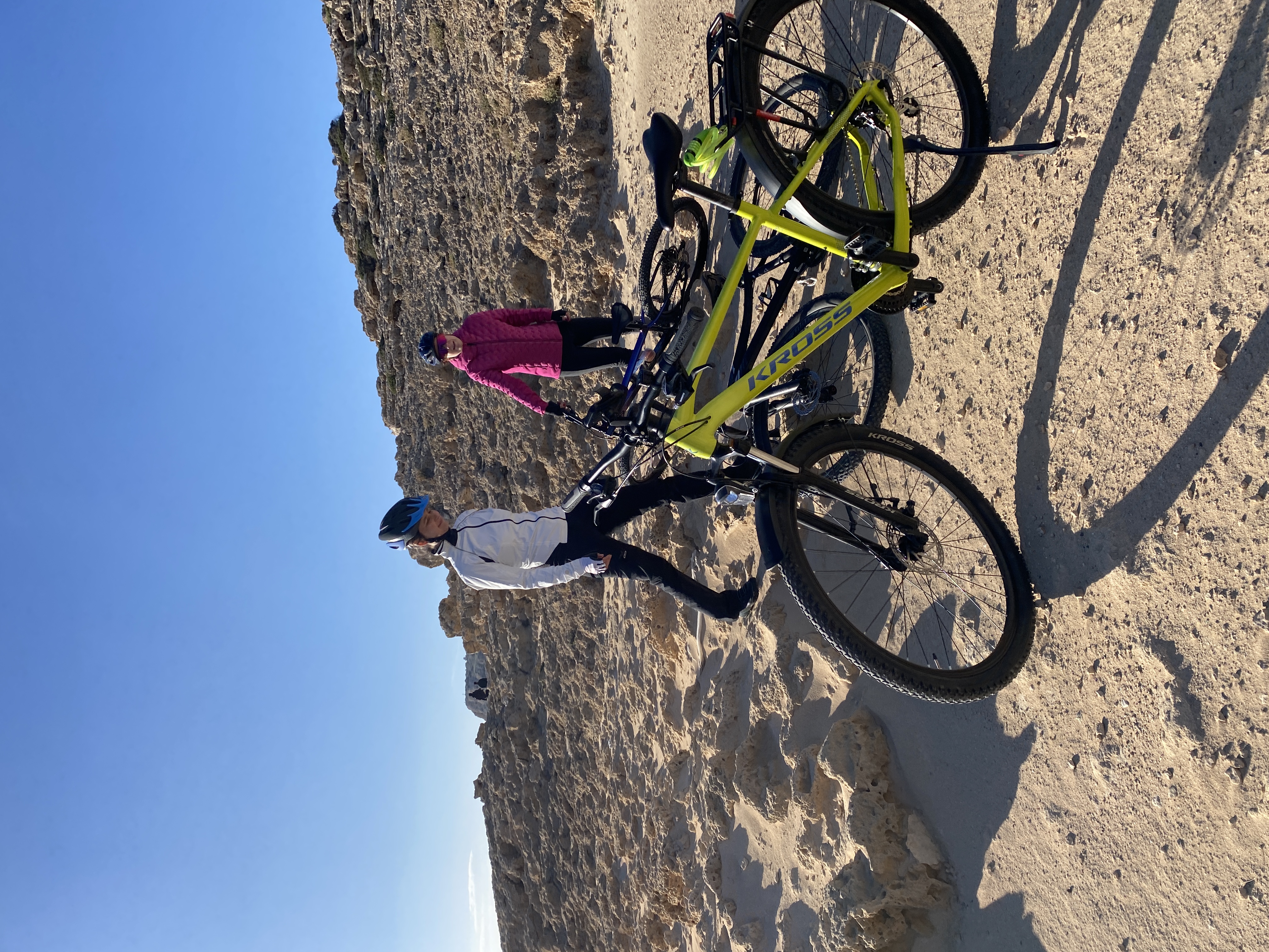 Cyclists resting along the Cape Greco coastline