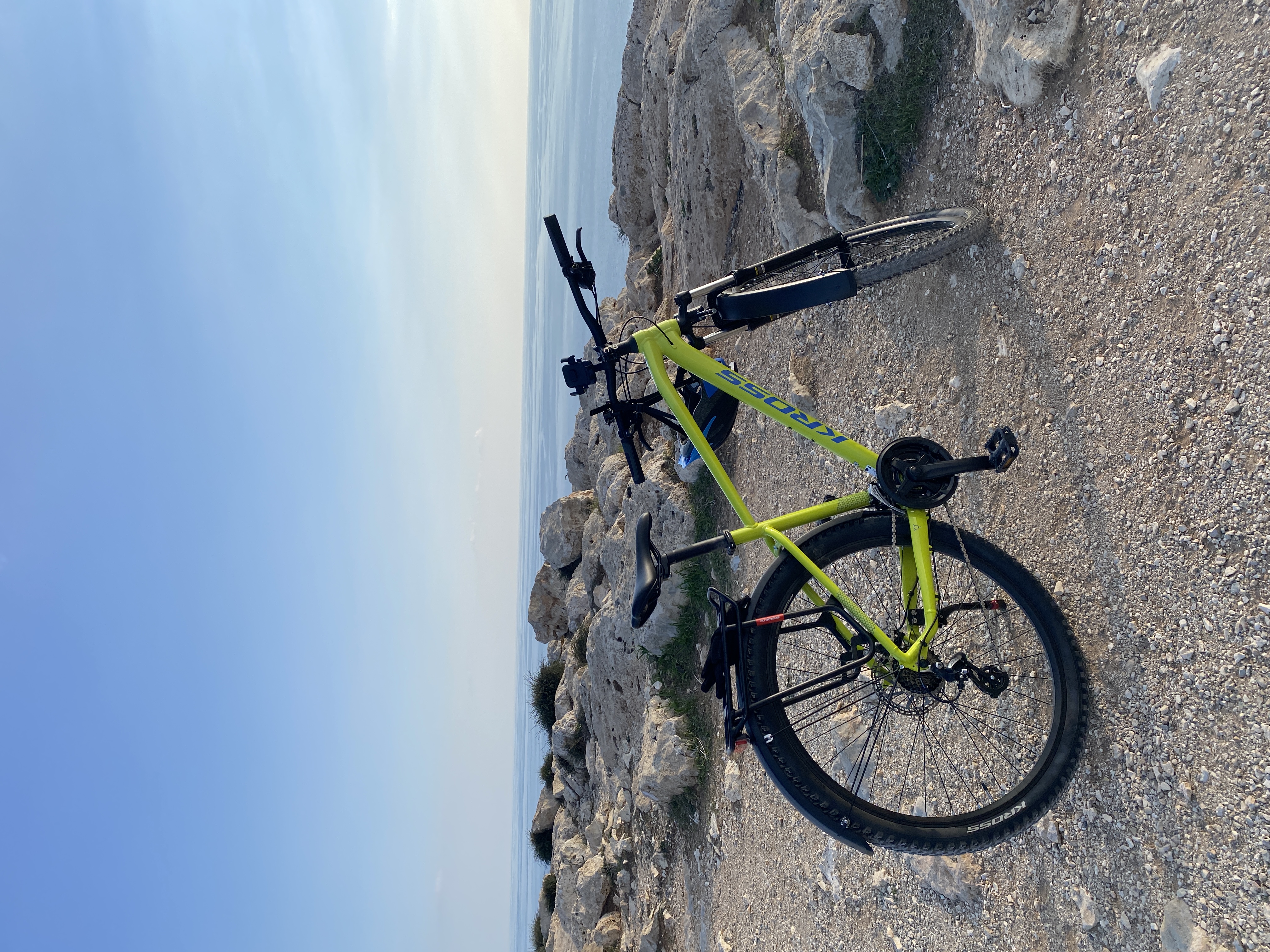 Bike resting on a cliff overlooking the sparkling Cyprus coastline