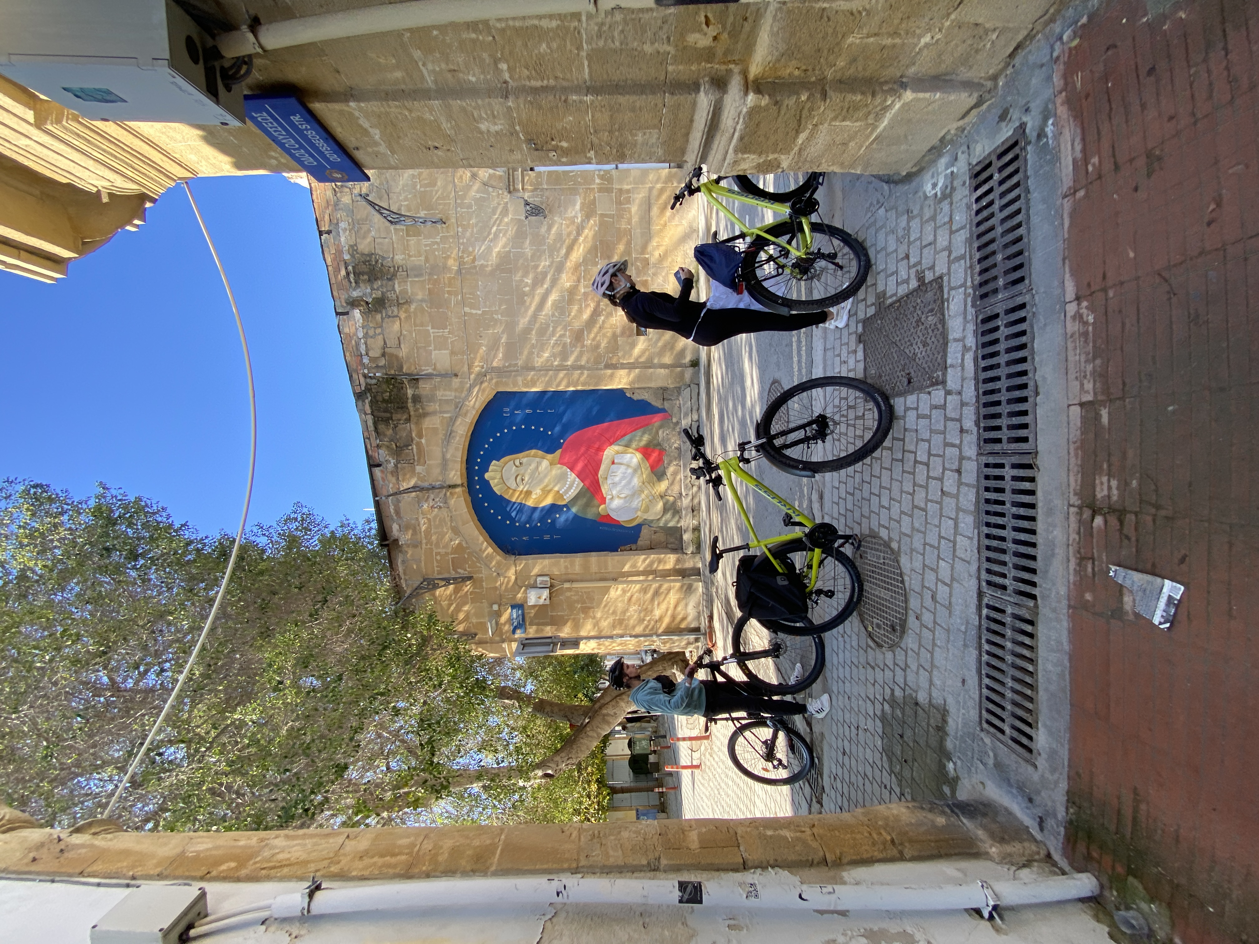 Cyclists exploring a lantern-lit Nicosia old town street